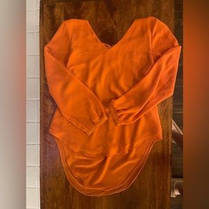 Orange long sleeve blouse with cutout detail on the back
